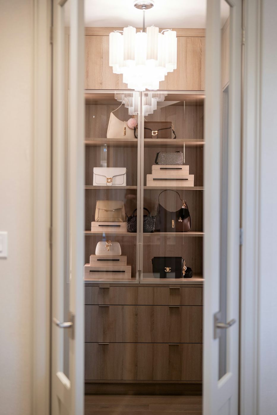 Fitted wardrobe interior lit by integrated LED strips along the hanging rails